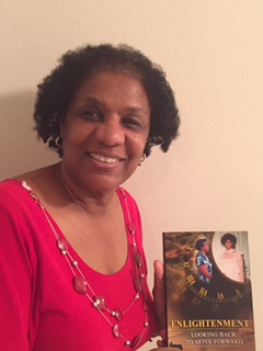 Picture of Debra holding her book up and smiling.